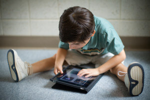 young child using ipad